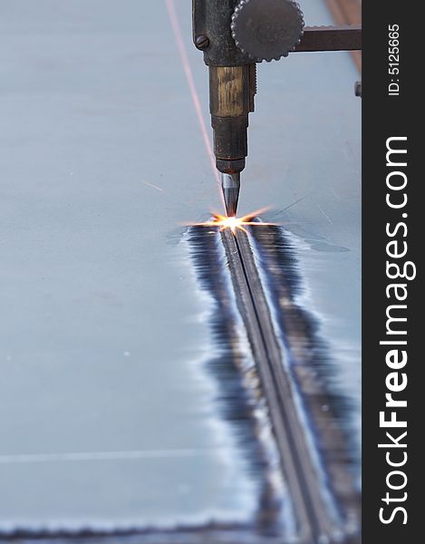 A close up of track torch burning steel