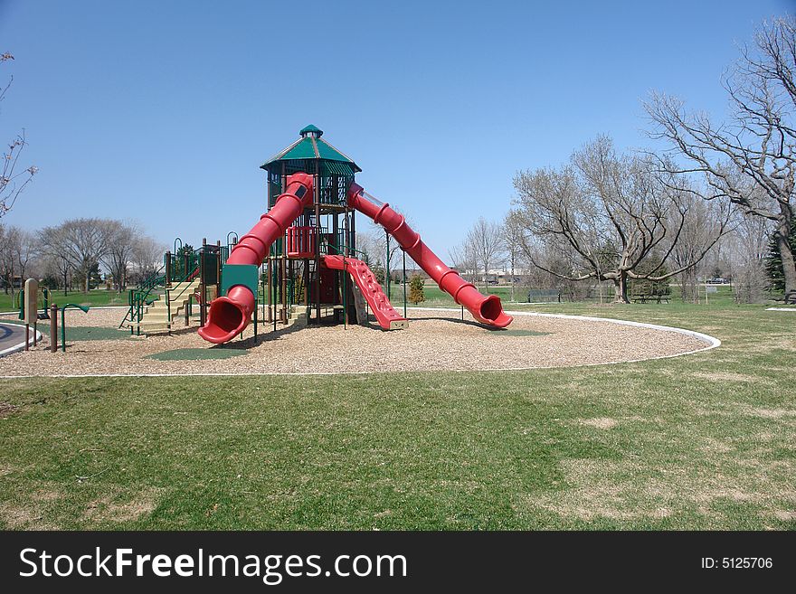 A picture of a playground in the park. A picture of a playground in the park