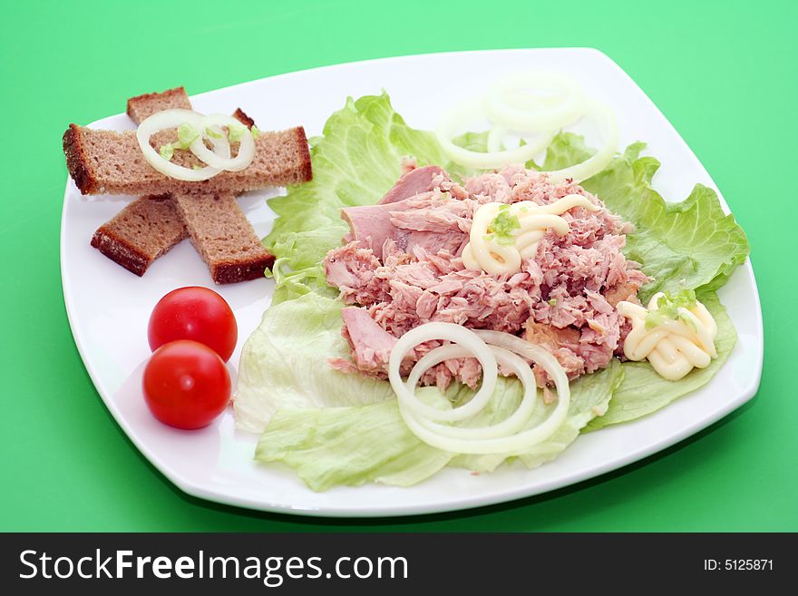 A fresh salad with fish and some bread