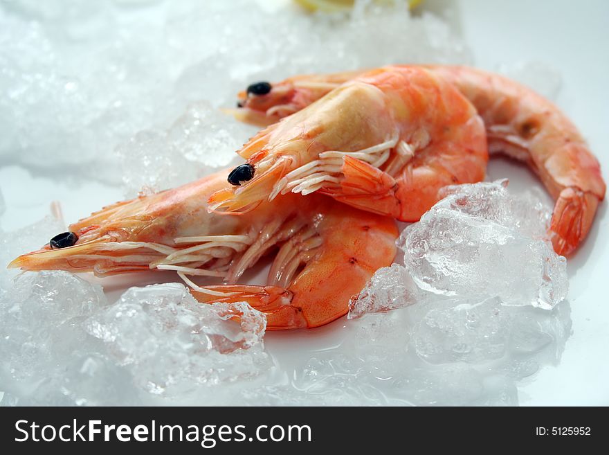 Some fresh shrimps on a wooden plate