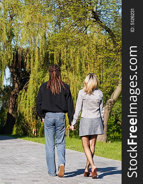 Couple walking on road away. Couple walking on road away