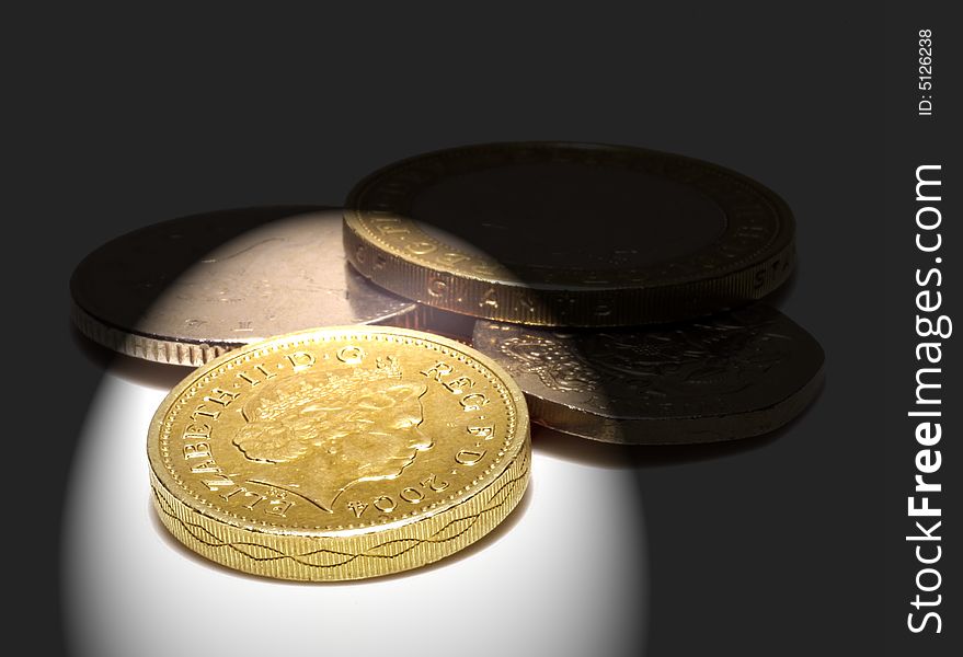 UK coins on white with spotlight effect