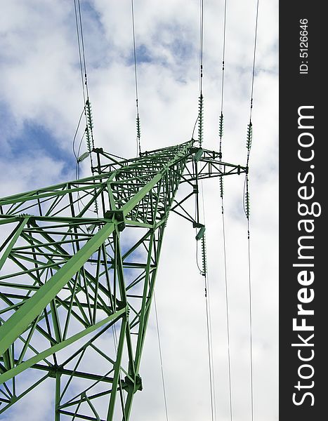 High-voltage transmission tower on a background of the cloudless sky. High-voltage transmission tower on a background of the cloudless sky.