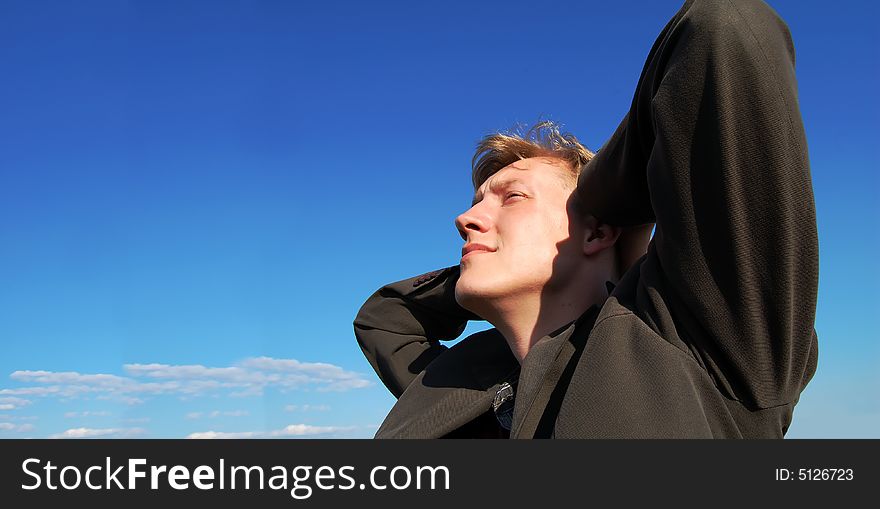 A young man having a rest and looking at clouds. A young man having a rest and looking at clouds