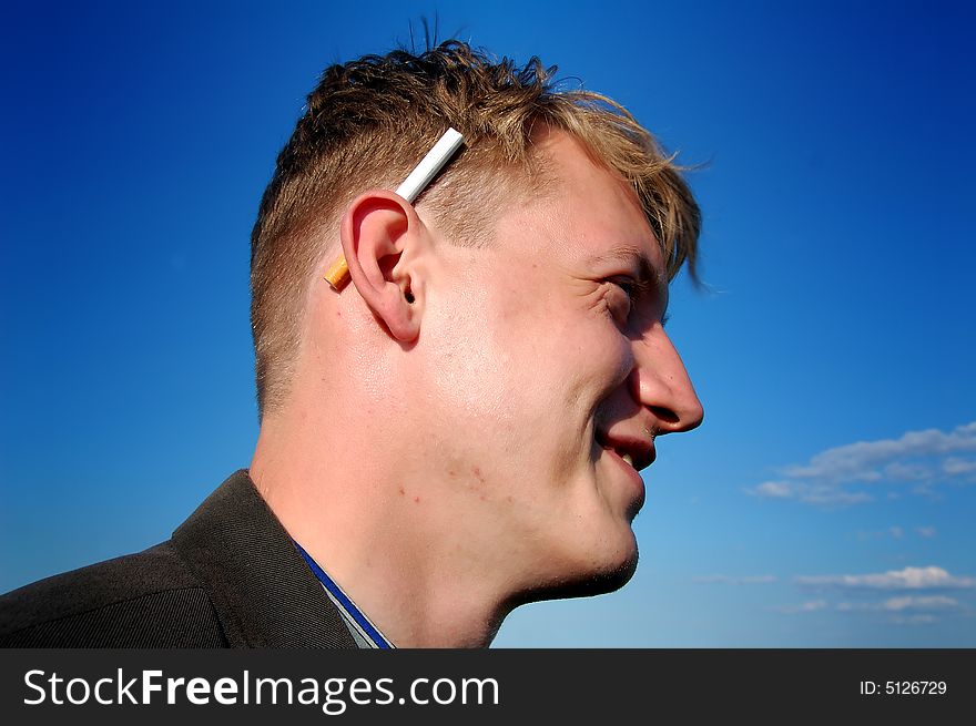 Portrait of a young man with a cigarette, by the sunny weather