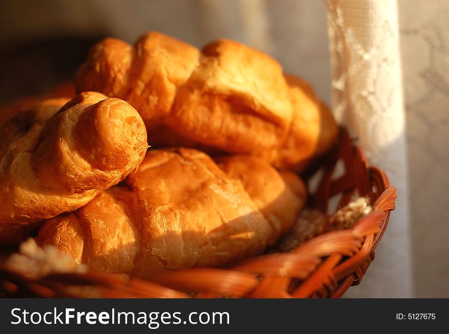 Fresh croissants in basket shot in morning light