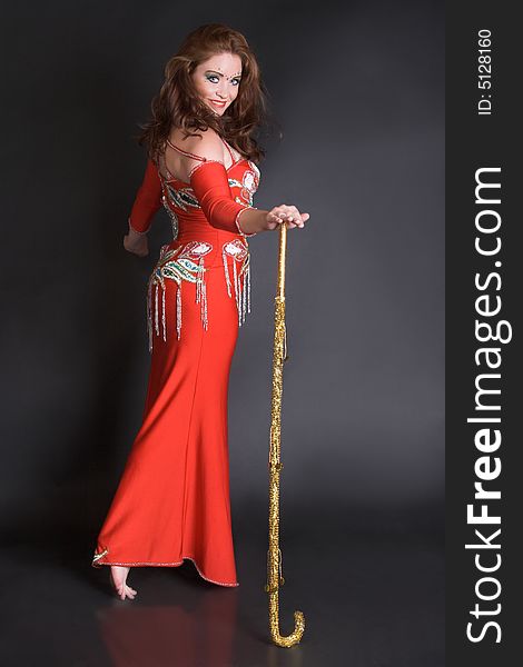 Belly dancer with tribal cane decorated in gold. Belly dancer with tribal cane decorated in gold