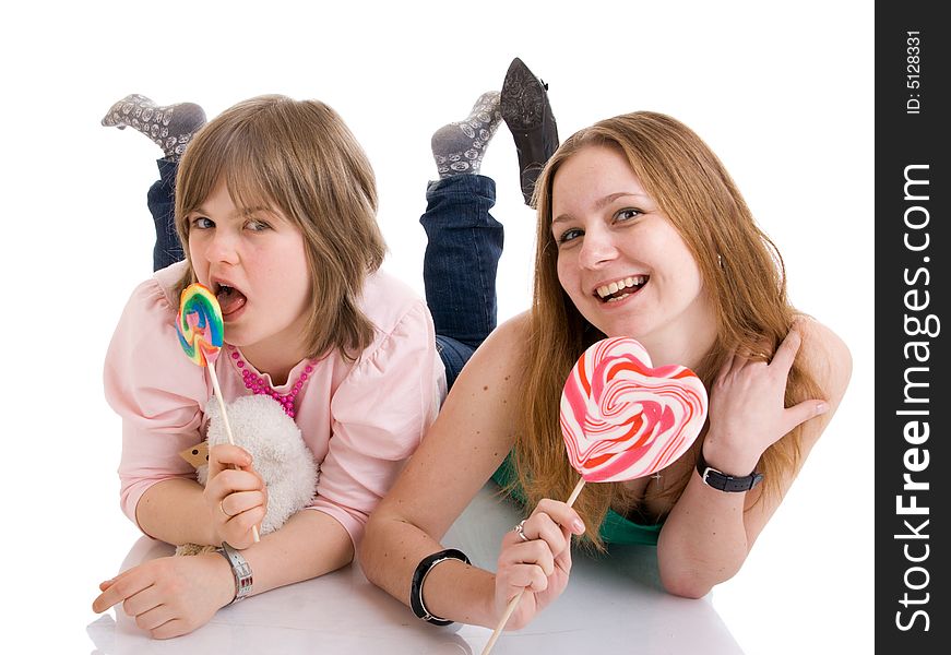 The Two Young Attractive Girls Isolated On A White