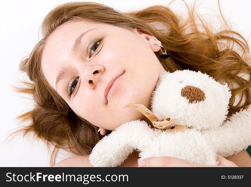 The young attractive girl with a teddy bear