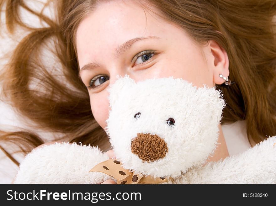 The young attractive girl with a teddy bear