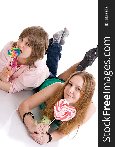 The two young attractive girls isolated on a white