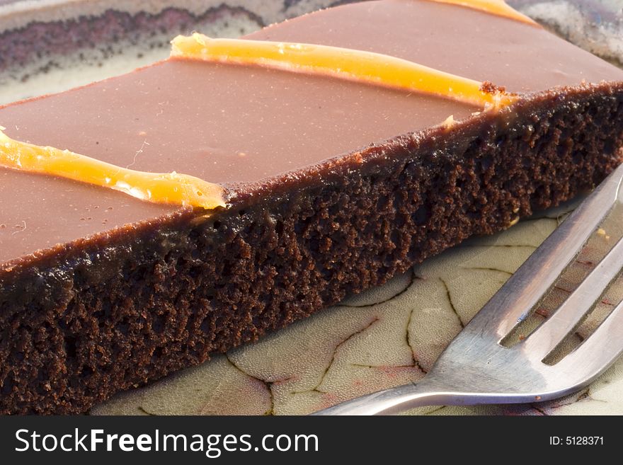 Chocolate cake and a fork on a plate