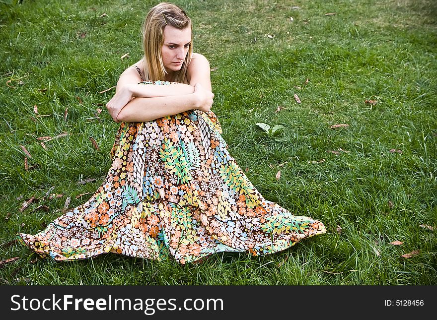 Young blond woman over the grass. Young blond woman over the grass.