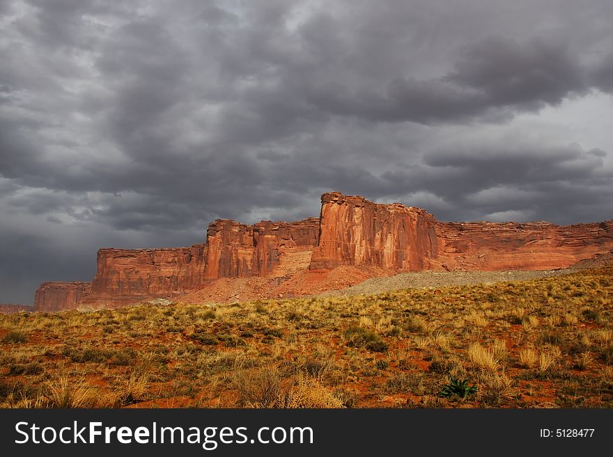 View of the red rock formations in Canyonlands National Park with storm clouds. View of the red rock formations in Canyonlands National Park with storm clouds