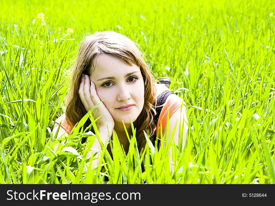 Young pensive woman trough the grass. Young pensive woman trough the grass