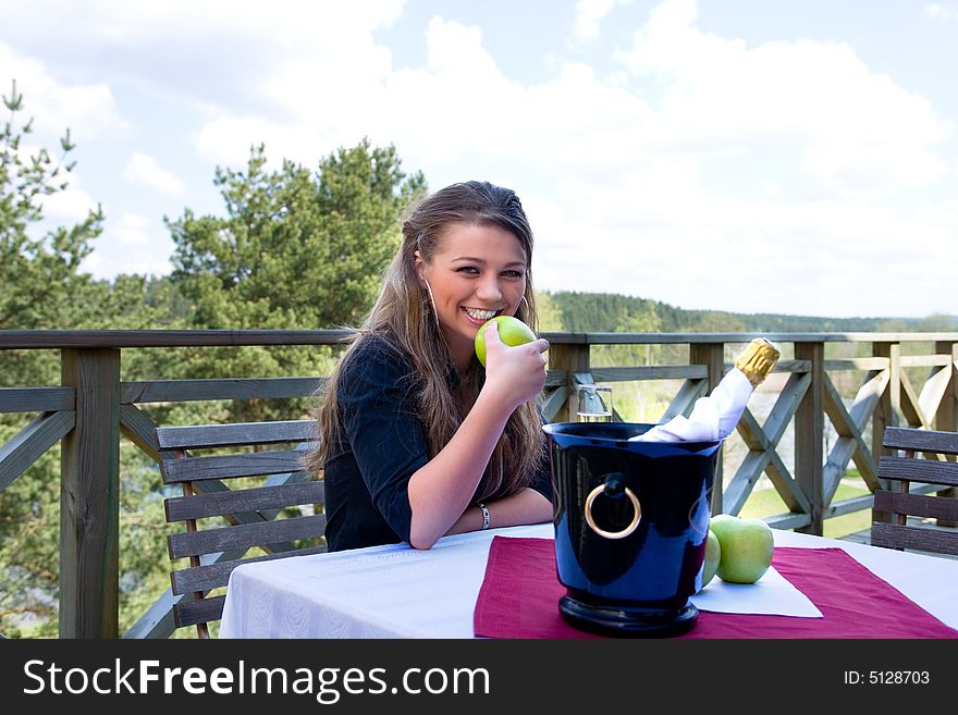 Young girl with apple on veranda