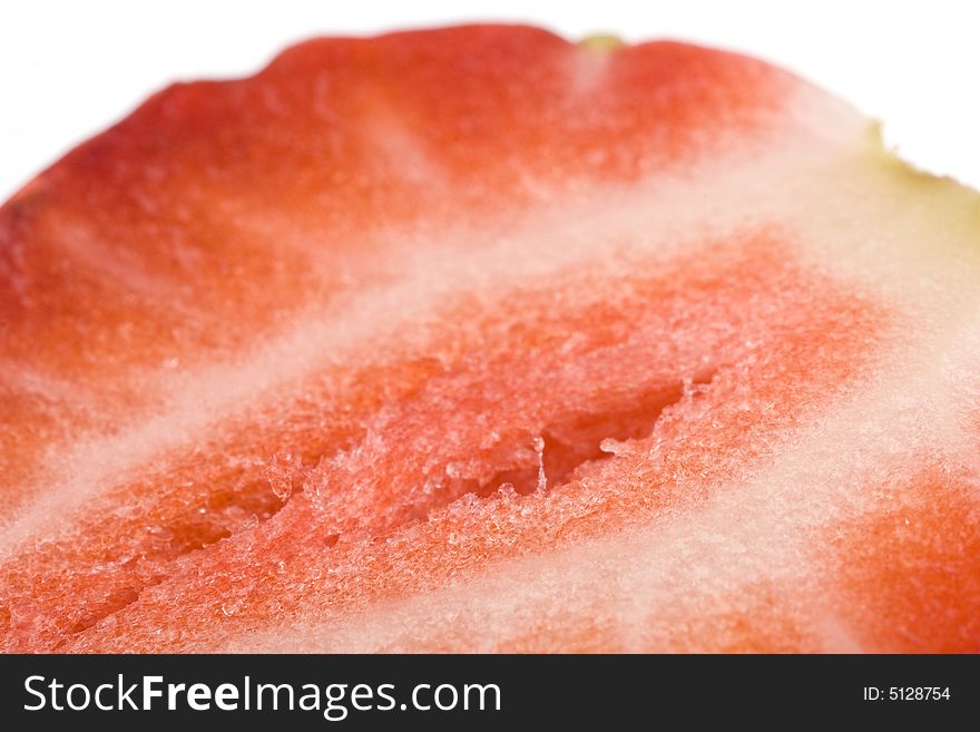 Close up of half of strawberry on a white