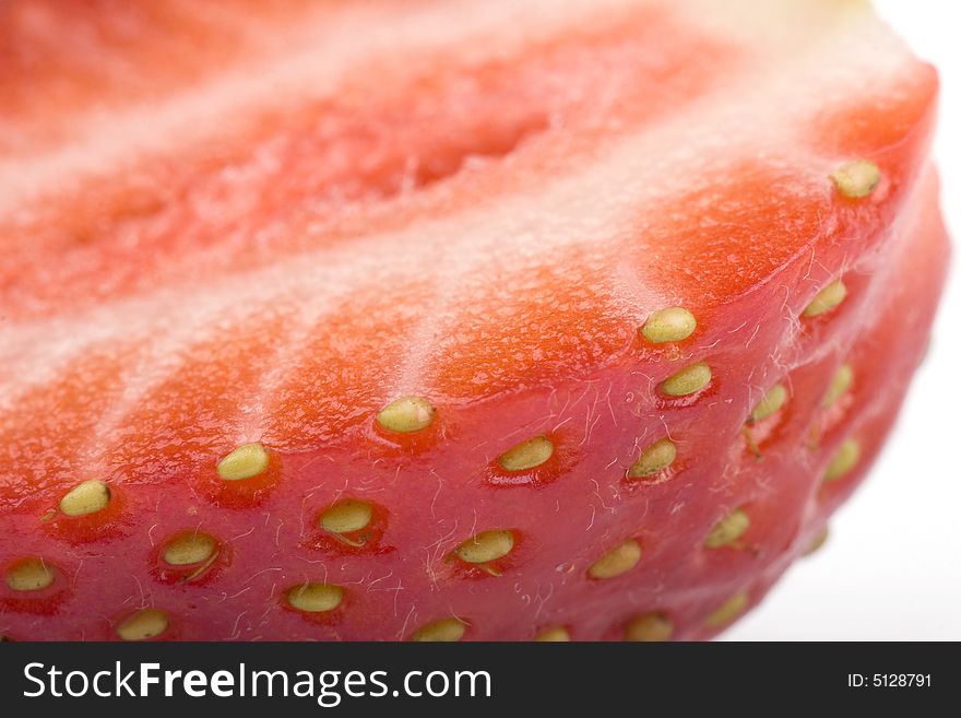 Close up of half of strawberry on a white