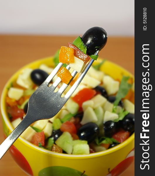 The Greek salad in a bright ceramic plate