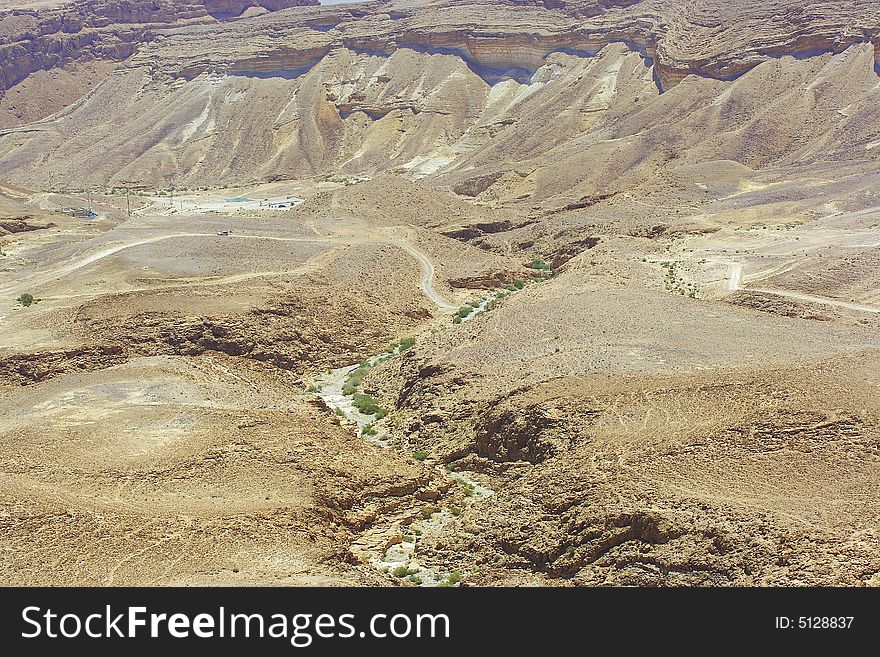 Hills and stones of Judean desert. Channel of the dried up river.