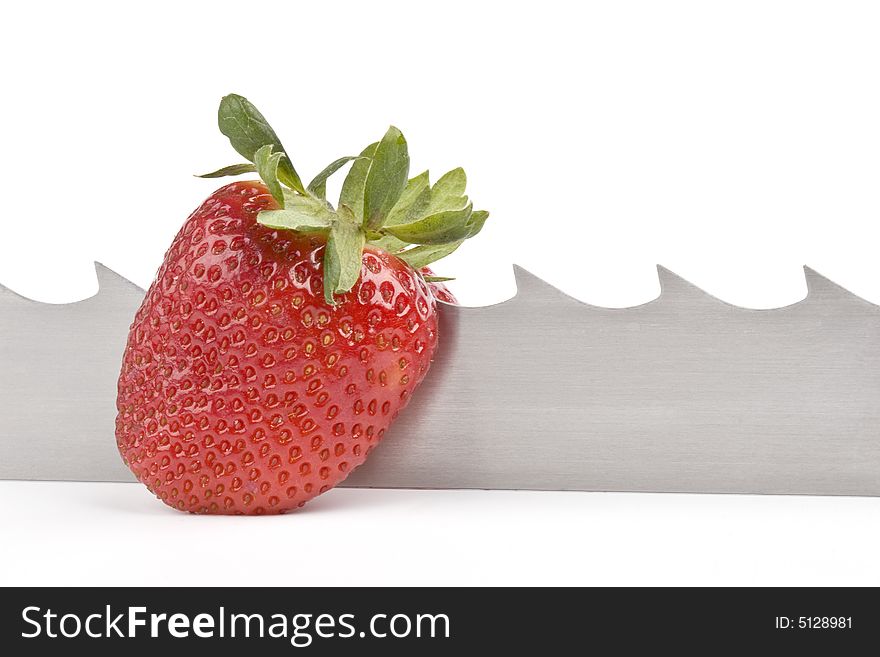 Strawberry and saw-blade on a white