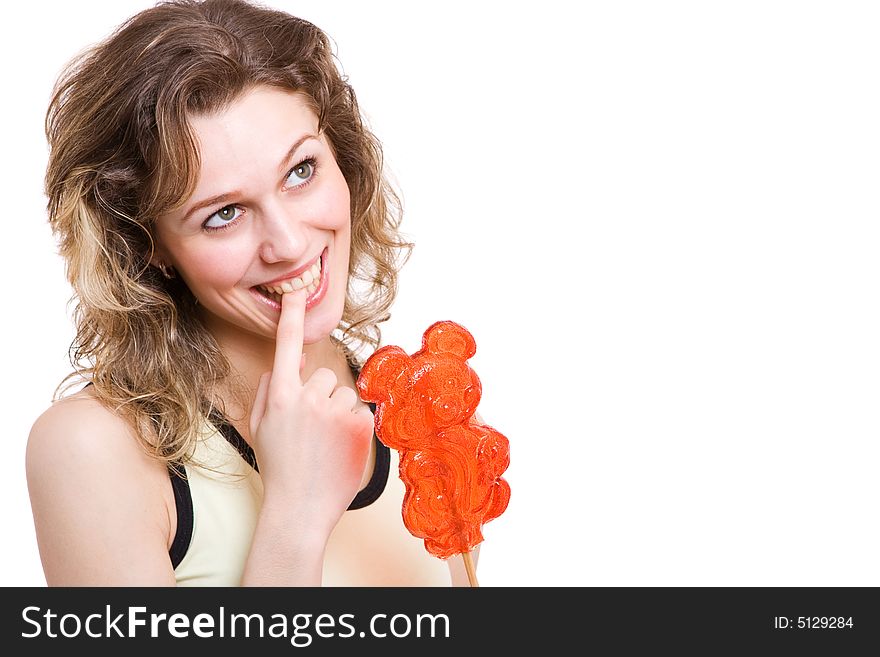 Girl with red lollipop in yellow clothes thinking to eat bonbon. Isolated in white. Girl with red lollipop in yellow clothes thinking to eat bonbon. Isolated in white.