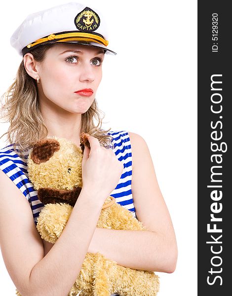 Woman captain in striped clother and her captain hat, taken hands her home small toy . Isolated in white. Woman captain in striped clother and her captain hat, taken hands her home small toy . Isolated in white