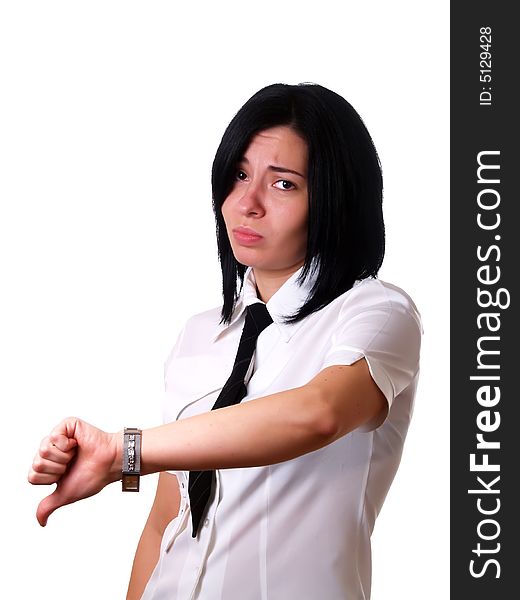 A portrait about a young pretty sad businesswoman with black hair who is giving the thumbs down and she is wearing a white shirt and a black tie. A portrait about a young pretty sad businesswoman with black hair who is giving the thumbs down and she is wearing a white shirt and a black tie