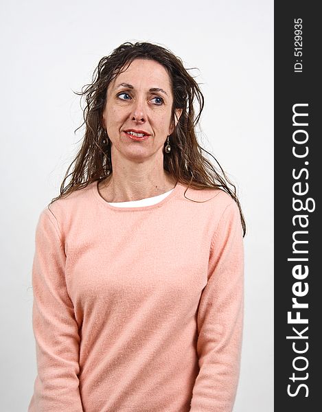 Attractive middle-aged caucasian woman with long brown hair, in a pink sweater. Attractive middle-aged caucasian woman with long brown hair, in a pink sweater.