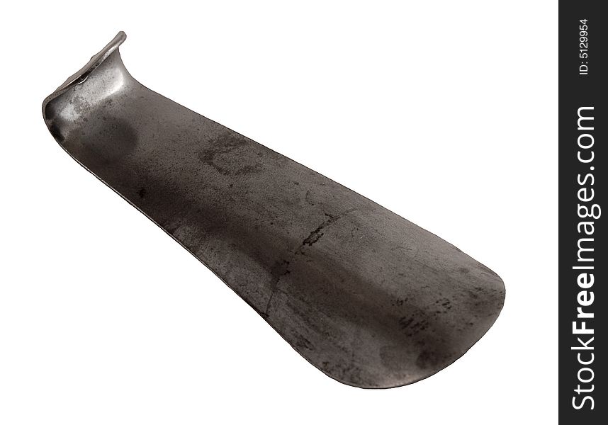 An old metal shoehorn on a white background