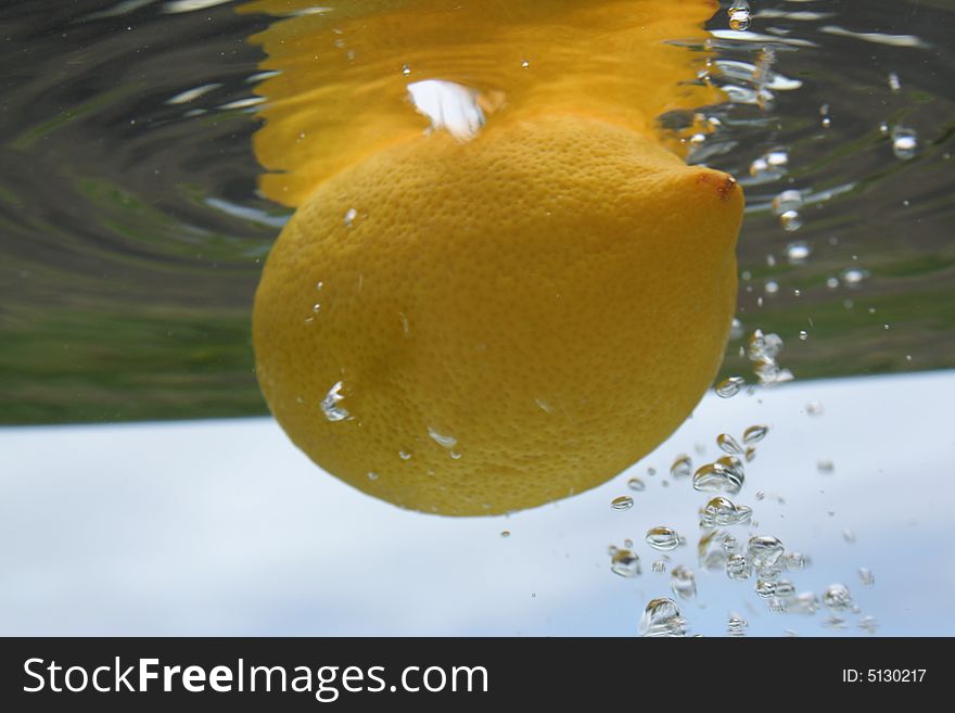 Underwater lemon with bubbles around it. Underwater lemon with bubbles around it