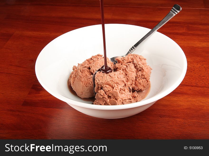 Delicious bowl of chocolate ice cream with chocolate sauce