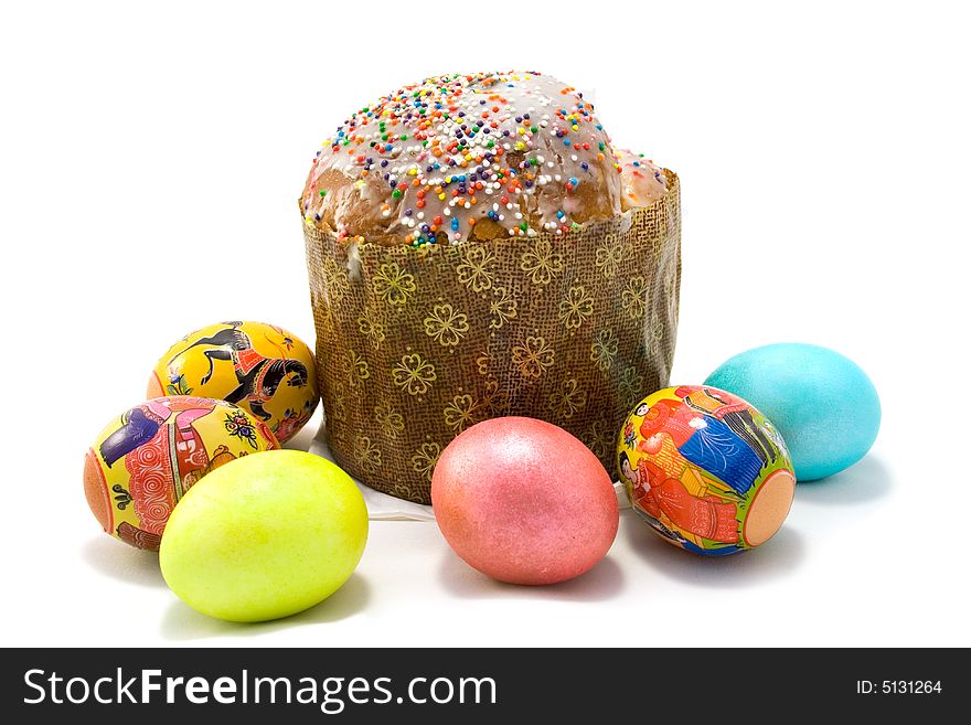 Easter cake and six Easter eggs on white background