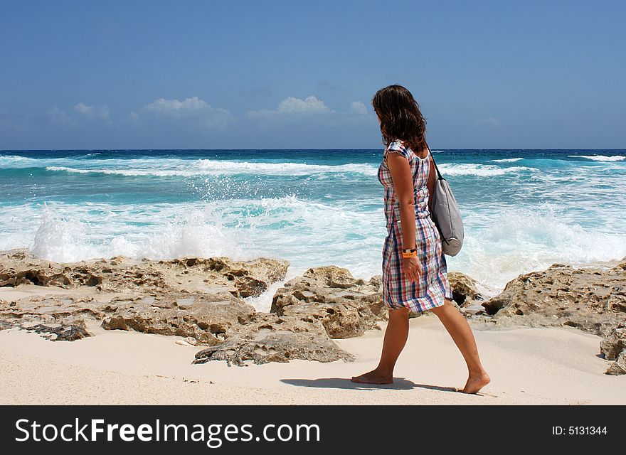 The girl is walking along the beach in Punta Sur Eco park on Cozumel island, Mexico. The girl is walking along the beach in Punta Sur Eco park on Cozumel island, Mexico.