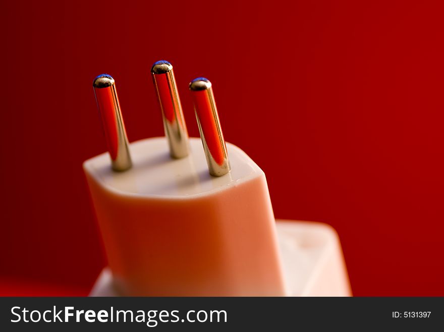 Power plug isolated on a red background. Power plug isolated on a red background