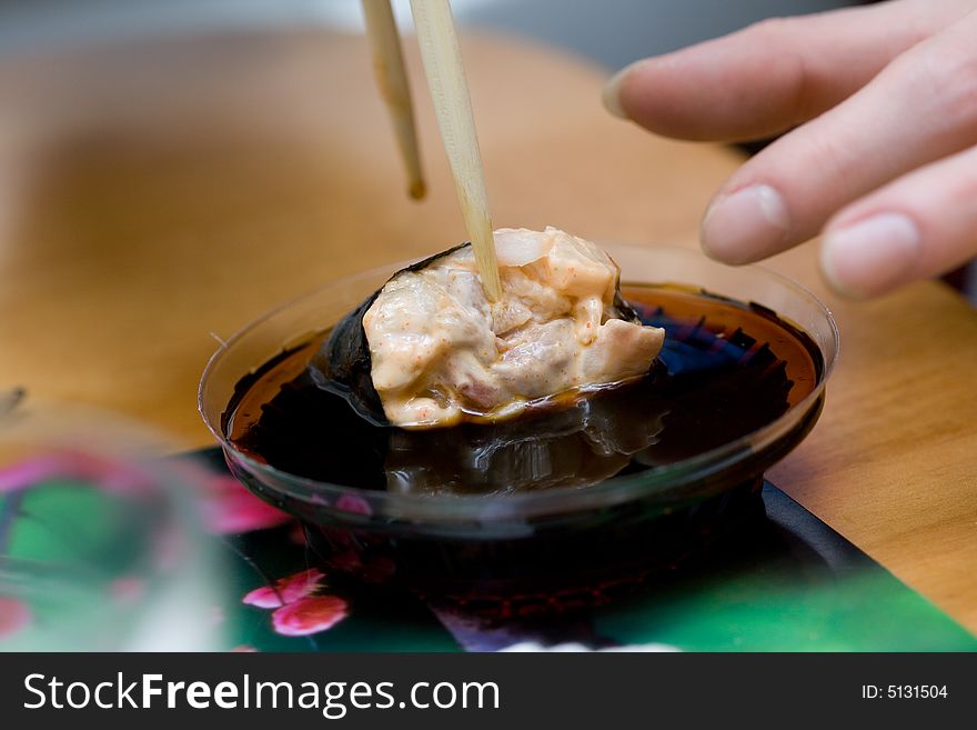 Taking sushi with pecten (mollusc). Taking sushi with pecten (mollusc)