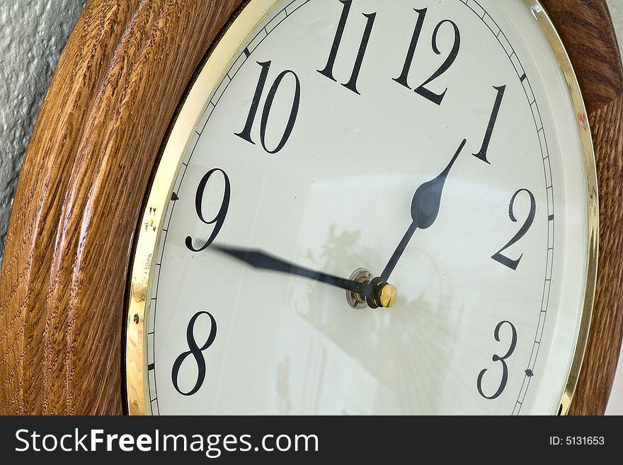 Image of a clock on a wall showing the minutes passing by. Image of a clock on a wall showing the minutes passing by.