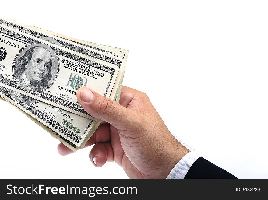 A hand grabbing the pack of $100 dollar bills. A hand grabbing the pack of $100 dollar bills