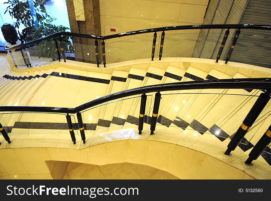 The upward staircase with ceramic stairs in a luxury building. The upward staircase with ceramic stairs in a luxury building.