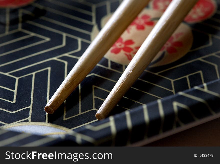 A japanese tray perfect with a pair of chopstick with natural side lighting. A japanese tray perfect with a pair of chopstick with natural side lighting