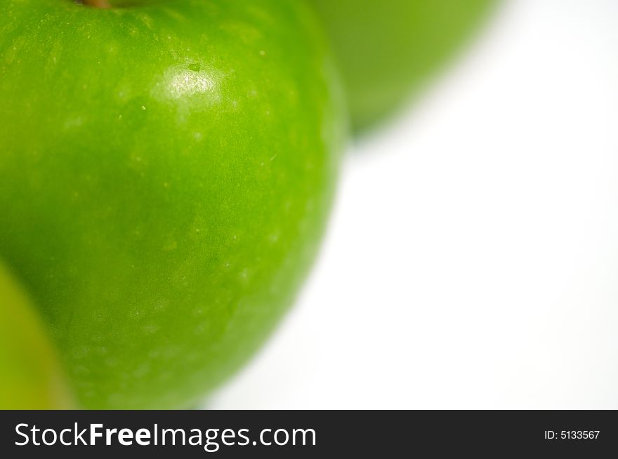 Fresh green apples on a white backdrop