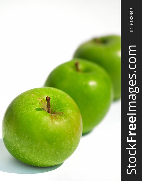 Fresh green apples on a white backdrop. Fresh green apples on a white backdrop