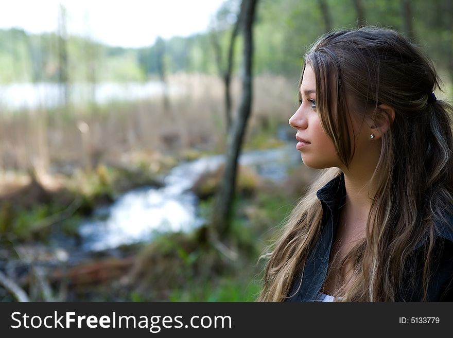 Portrait of young girl on forest background