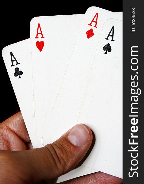 An image of four aces in a person's hand. An image of four aces in a person's hand.