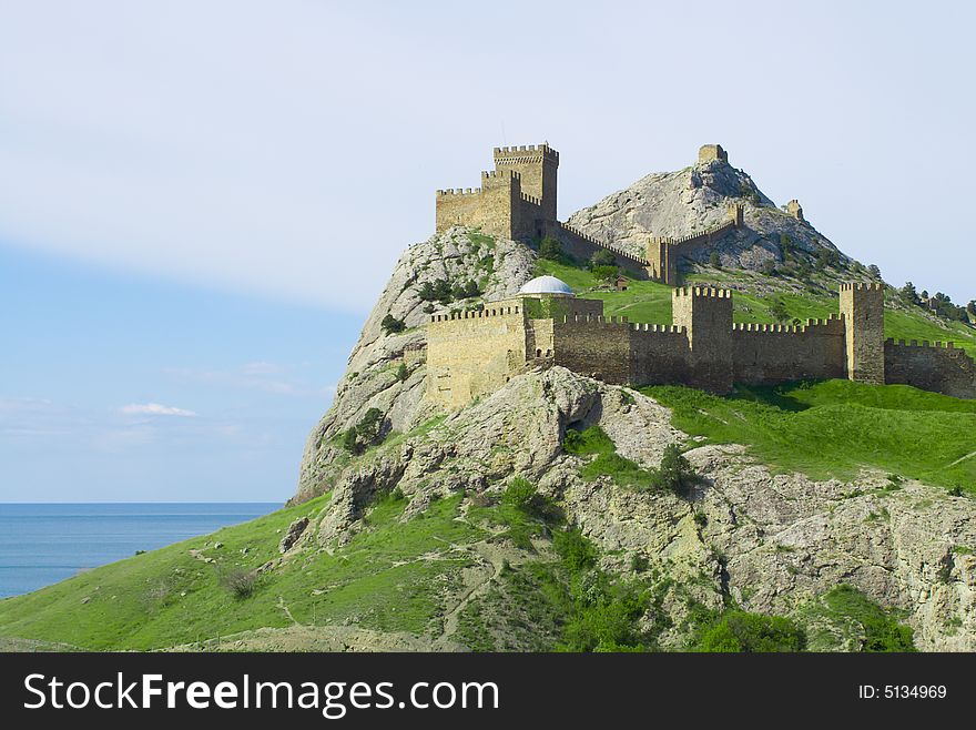 Genoese Fortress On Green Mountain Over Sea