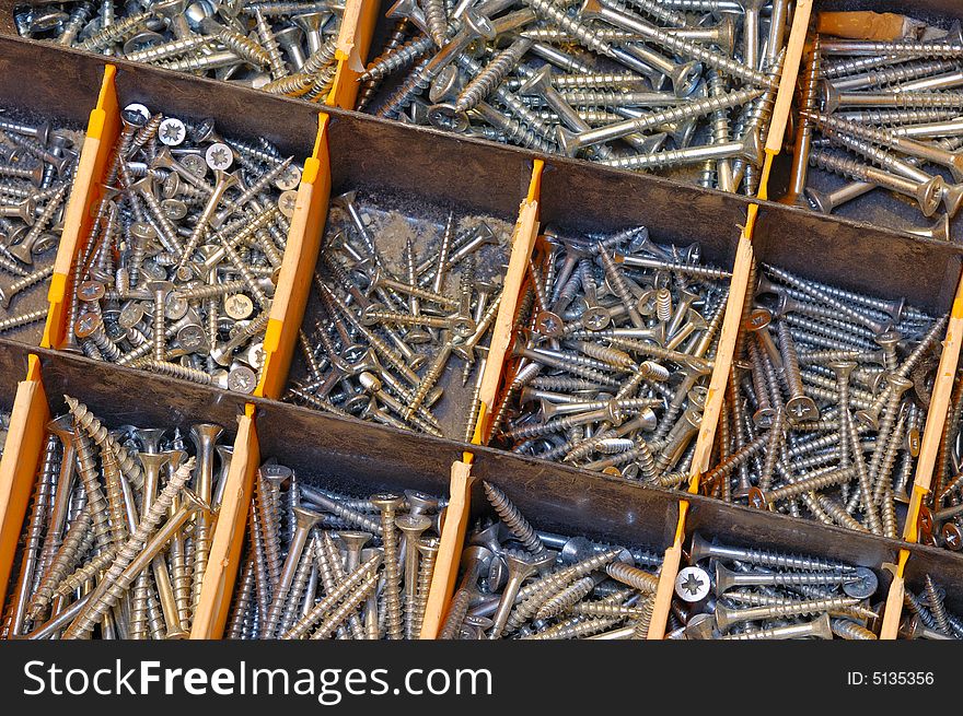 Close up of a selection of screws in a workman's toolbox