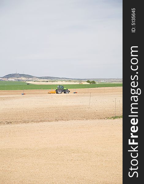 Tractor at a field in albacete region from spain europe. Tractor at a field in albacete region from spain europe