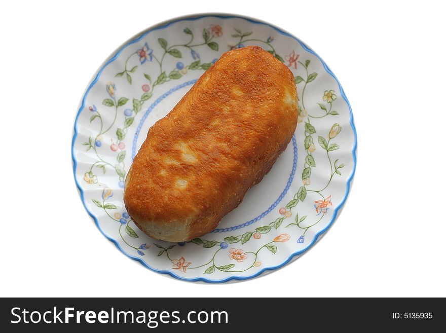 Roasted pie at plate  on a white background