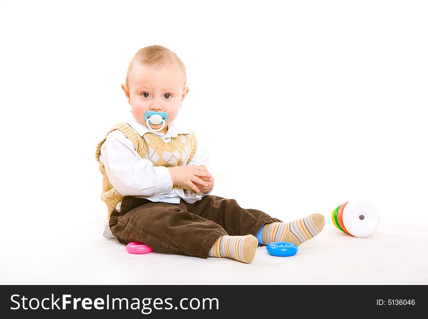 Small boy with pacifier plays on the floor. Small boy with pacifier plays on the floor