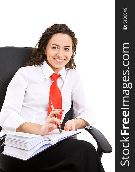 Businesswoman seat in armchair and holds pen and book. Businesswoman seat in armchair and holds pen and book